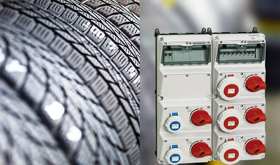 a light yellow AMAXX receptacle combination in front of a close-up of a car tire